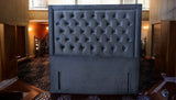 Close-up detail of KIM headboard showing deep button tufting and premium black fabric texture